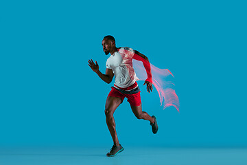 Image showing Full length portrait of active young muscular running man,