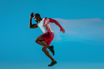 Image showing Full length portrait of active young muscular running man,
