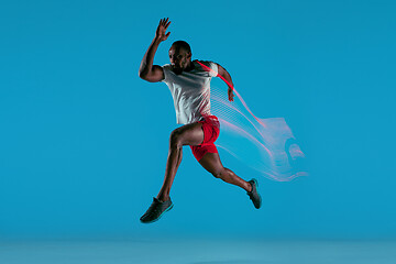 Image showing Full length portrait of active young muscular running man,