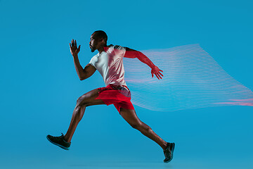 Image showing Full length portrait of active young muscular running man,