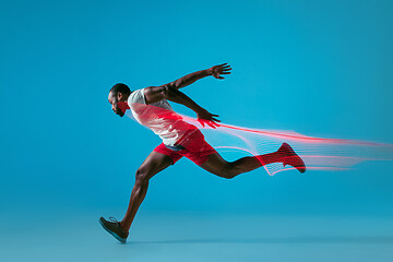 Image showing Full length portrait of active young muscular running man,