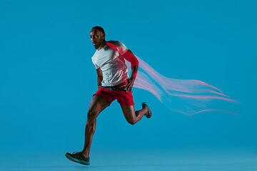 Image showing Full length portrait of active young muscular running man,