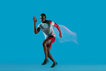 Image showing Full length portrait of active young muscular running man,