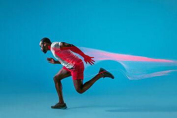 Image showing Full length portrait of active young muscular running man,