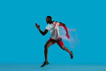 Image showing Full length portrait of active young muscular running man,