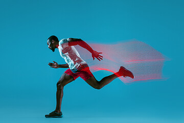 Image showing Full length portrait of active young muscular running man,