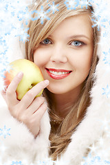 Image showing lovely blond in fur with apple