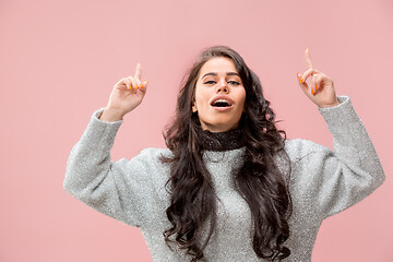 Image showing The happy business woman standing and smiling against pastel background.