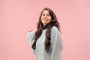 Image showing The happy business woman standing and smiling against pastel background.