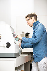 Image showing woman hone the edge of the eyeglasses