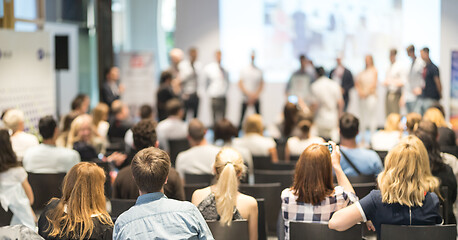 Image showing Young business team receiving award at best business project competition event.