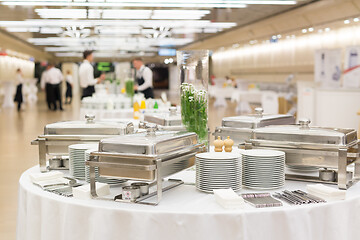 Image showing Waiters prepare buffet before a coffee break at business conference meeting.