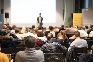 Image showing Business speaker giving a talk at business conference event.