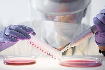 Image showing Scientist working in the corona virus vaccine development laboratory research with a highest degree of protection gear.