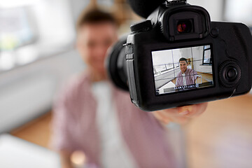 Image showing close up of camera recording male video blogger