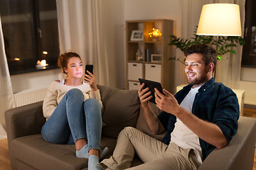 Image showing couple with tablet computer and smartphone at home