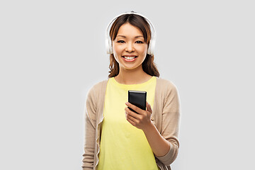 Image showing asian woman in headphones listening to music