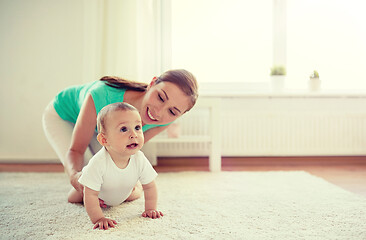 Image showing happy mother playing with baby at home