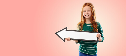 Image showing smiling red haired girl with arrow showing to left