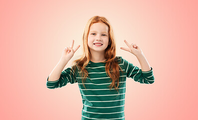 Image showing smiling red haired girl showing peace gesture