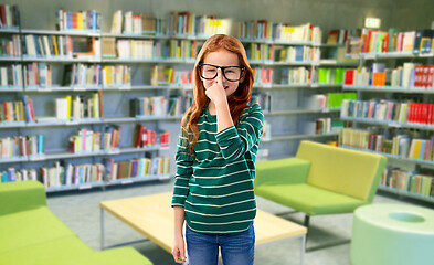Image showing red haired student girl in glasses at library