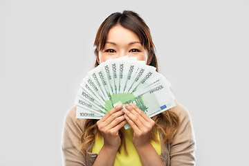 Image showing asian woman with hundred euro money banknotes