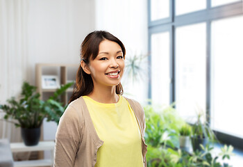 Image showing happy asian woman over home background