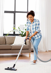 Image showing woman or housewife with vacuum cleaner at home