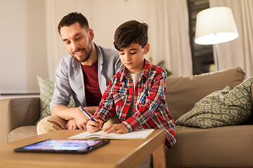 Image showing father and son doing homework together