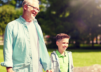 Image showing grandfather and grandson walking at summer park