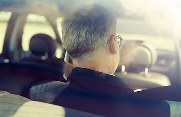 Image showing senior businessman calling on smartphone in car