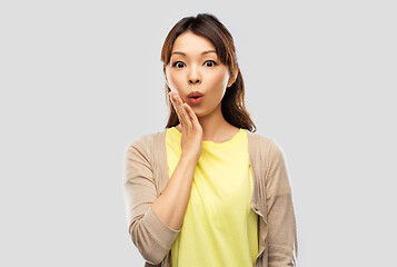 Image showing surprised asian woman over grey background