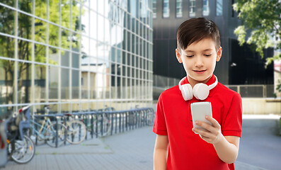 Image showing boy in red t-shirt with headphones and smartphone