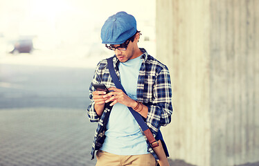 Image showing hipster man texting message on smartphone