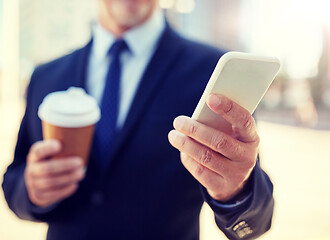 Image showing senior businessman with smartphone and coffee