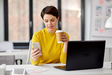 Image showing businesswoman calling on smartphone at office