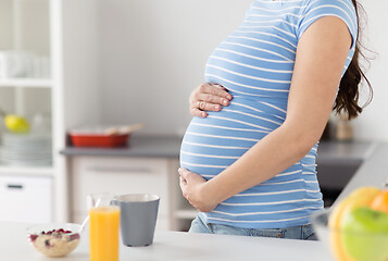 Image showing close up of pregnant woman touching her belly