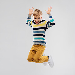 Image showing happy little boy jumping and having fun