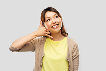 Image showing african asian making phone call gesture