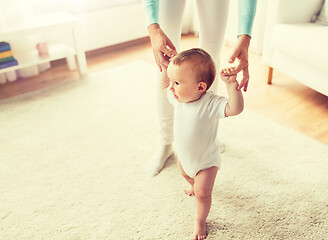 Image showing happy baby learning to walk with mother help