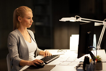 Image showing businesswoman at computer working at night office