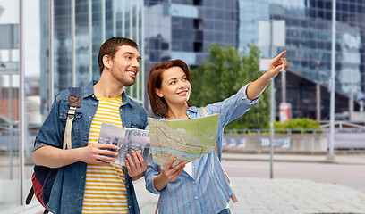 Image showing happy couple of tourists with city guide and map