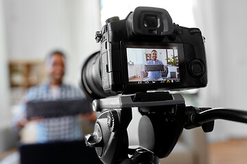 Image showing camera recording blogger with computer keyboard