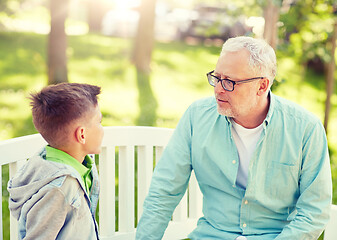 Image showing grandfather and grandson talking at summer park