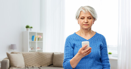 Image showing senior woman using smartphone at home