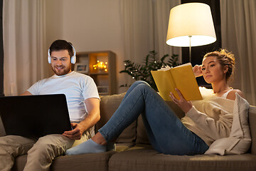 Image showing couple with laptop computer and book at home