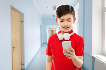 Image showing boy in red t-shirt with headphones and smartphone