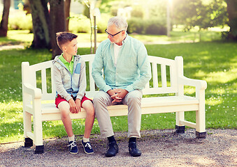 Image showing grandfather and grandson talking at summer park