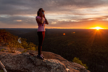 Image showing Athletic woman wearing a medical protection mask outdoors in nat