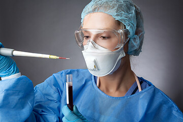 Image showing Medical pathologist or research scientist working in a lab with 